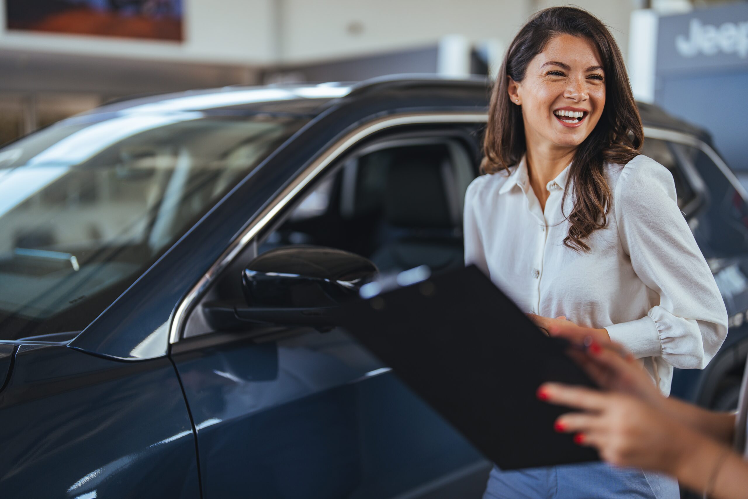 Car,Dealership,Manager,Helps,A,Client,Choose,A,Car.,Female Dealership Event Marketing