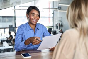 african american woman talking with a woman in an office